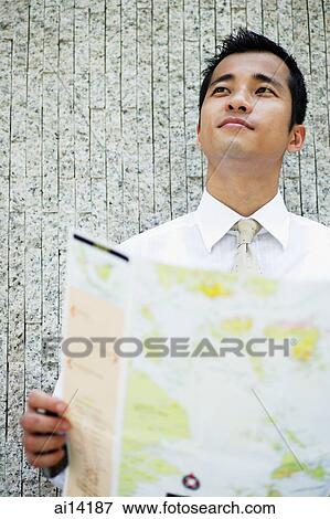 Executive holding map, looking away View Large Photo Image Stock Photo - Executive holding map, looking away. Fotosearch