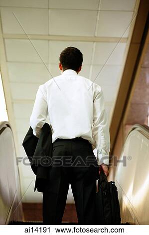 Executive on escalator, rearview View Large Photo Image Stock Image - Executive on escalator, rearview. Fotosearch