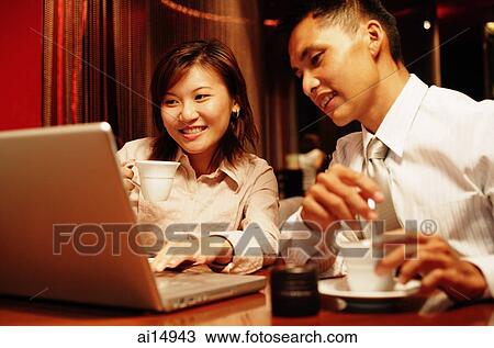Executives looking at laptop View Large Photo Image Stock Image - Executives looking at laptop. Fotosearch