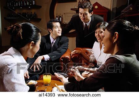 Executives sitting together having drinks View Large Photo Image Stock Image - Executives sitting together having drinks. Fotosearch