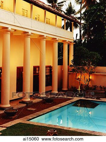 Exterior of building with garden and pool at night View Large Photo Image Stock Image - Exterior of building with garden and pool at night. Fotosearch