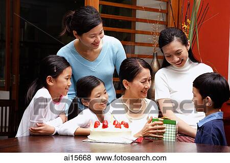 Family celebrating grandmothers birthday View Large Photo Image Stock Photo - Family celebrating grandmothers birthday. Fotosearch
