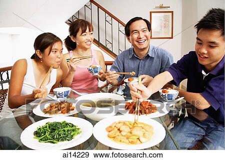 Stock Photo - Family eating at home. Fotosearch