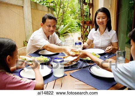 Family having meal, father passing son food View Large Photo Image Stock Image - Family having meal, father passing son food. Fotosearch