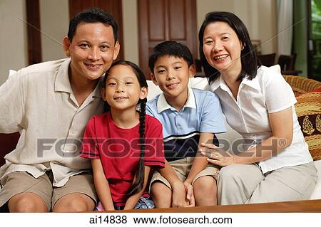 Family in living room, looking at camera, portrait View Large Photo Image Stock Photo - Family in living room, looking at camera, portrait. Fotosearch