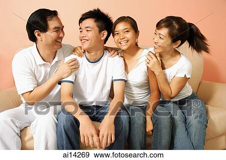 Family in living room, looking away View Large Photo Image Stock Photo - Family in living room, looking away. Fotosearch