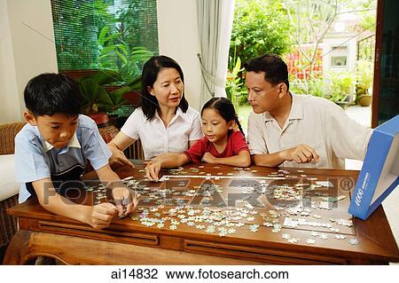 Family in living room, playing jigsaw puzzle View Large Photo Image Stock Image - Family in living room, playing jigsaw puzzle. Fotosearch