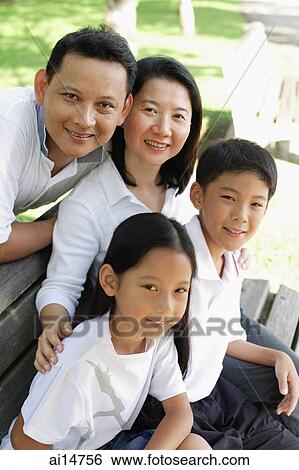 Stock Photograph - Family looking at camera, outdoor. Fotosearch