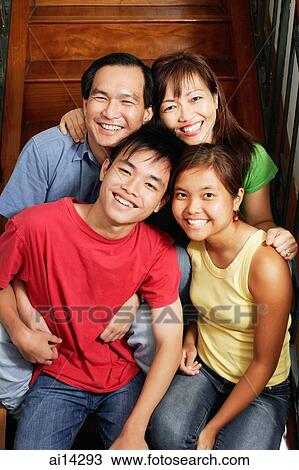 Family of four sitting on stairs, portrait View Large Photo Image Stock Image - Family of four sitting on stairs, portrait. Fotosearch