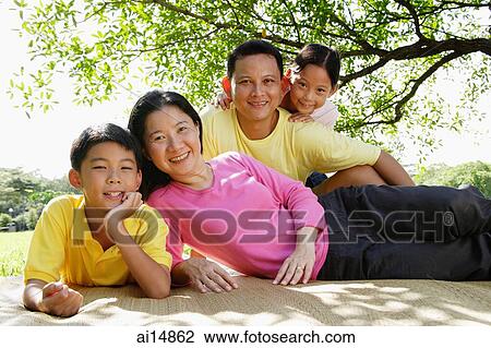 Family on picnic mat, looking at camera View Large Photo Image Stock Image - Family on picnic mat, looking at camera. Fotosearch