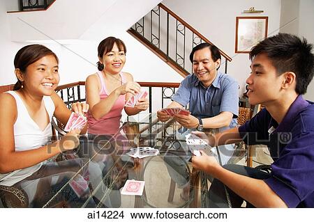 Family playing cards around table View Large Photo Image Picture - Family playing cards around table. Fotosearch