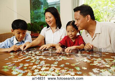 Family playing jigsaw puzzle in living room View Large Photo Image Stock Image - Family playing jigsaw puzzle in living room. Fotosearch