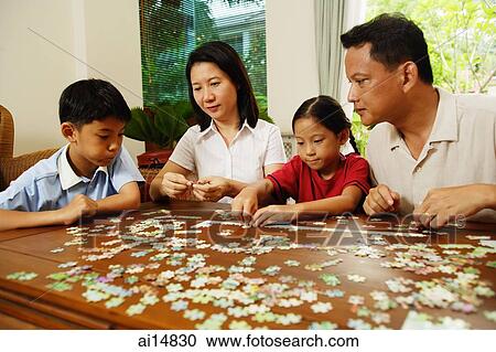 Family playing with jigsaw puzzle, indoor View Large Photo Image Stock Image - Family playing with jigsaw puzzle, indoor. Fotosearch