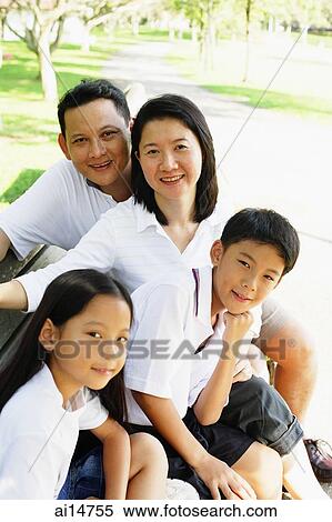 Family sitting on bench looking at camera, outdoor View Large Photo Image Stock Photography - Family sitting on bench looking at camera, outdoor. Fotosearch