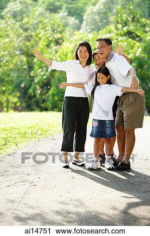 Stock Image - Family standing together, smiling. Fotosearch