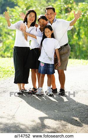Family standing together, smiling, waving View Large Photo Image Stock Image - Family standing together, smiling, waving. Fotosearch