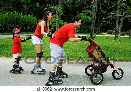 Family wearing roller blades, skating all in a row, father pushing stroller View Large Photo Image Stock Image - Family wearing roller blades, skating all in a row, father pushing stroller. Fotosearch