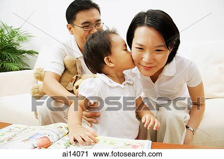 Stock Image - Family with one child, daughter kissing mother. Fotosearch