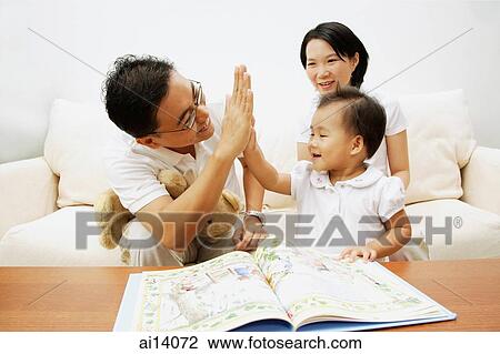 Family with one child, father giving daughter high five View Large Photo Image Stock Image - Family with one child, father giving daughter high five. Fotosearch