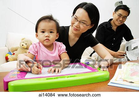 Family with one child in living room, looking at camera View Large Photo Image Picture - Family with one child in living room, looking at camera. Fotosearch
