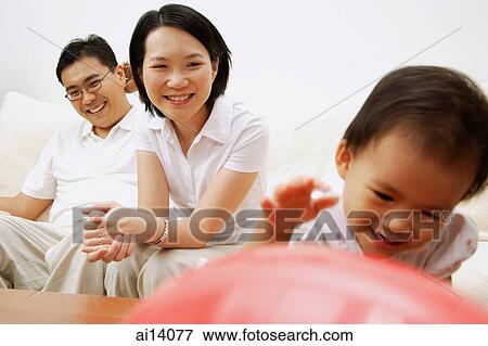 Family with one child, mother and father watching daughter View Large Photo Image Stock Photo - Family with one child, mother and father watching daughter. Fotosearch