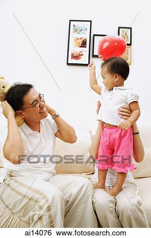 Family with one child, mother carrying daughter, father carrying stuffed toy View Large Photo Image Stock Photograph - Family with one child, mother carrying daughter, father carrying stuffed toy. Fotosearch