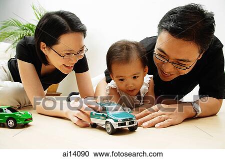 Family with one child, playing with cars View Large Photo Image Stock Image - Family with one child, playing with cars. Fotosearch