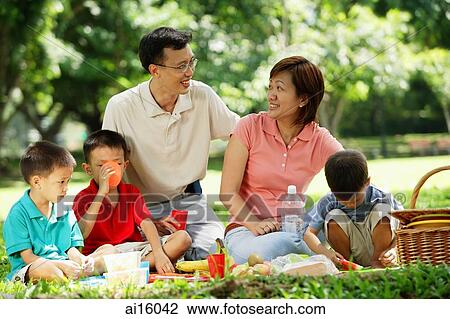 Family with three boys having picnic in park View Large Photo Image Stock Image - Family with three boys having picnic in park. Fotosearch