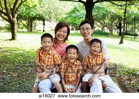 Family with three boys in park, smiling at camera View Large Photo Image Stock Photo - Family with three boys in park, smiling at camera. Fotosearch