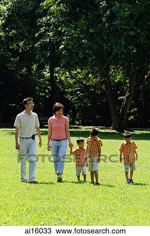 Family with three boys in park, walking View Large Photo Image Stock Image - Family with three boys in park, walking. Fotosearch