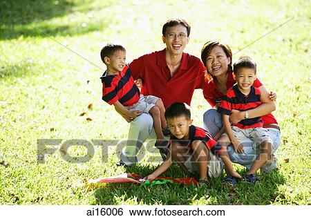 Family with three boys on field, portrait View Large Photo Image Stock Photograph - Family with three boys on field, portrait. Fotosearch