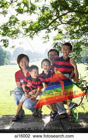 Family with three boys, outdoors, smiling at camera View Large Photo Image Stock Image - Family with three boys, outdoors, smiling at camera. Fotosearch