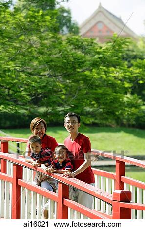 Stock Image - Family with two boys on bridge. Fotosearch