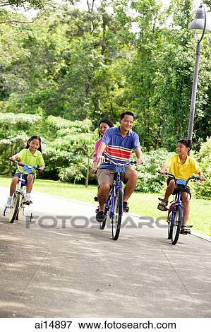 Family with two children, cycling side by side View Large Photo Image Stock Photo - Family with two children, cycling side by side. Fotosearch