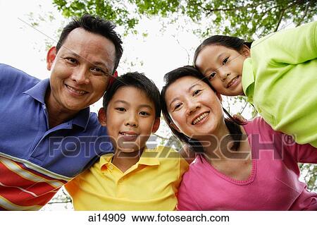 Family with two children, looking at camera View Large Photo Image Stock Photo - Family with two children, looking at camera. Fotosearch
