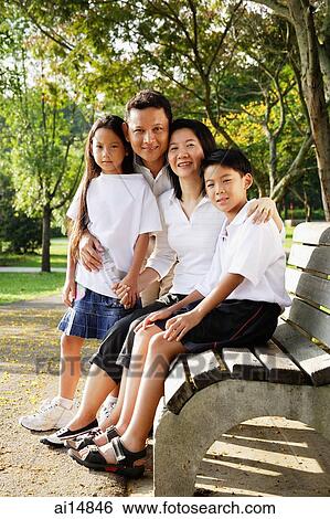 Stock Photograph - Family with two children, looking at camera, portrait. Fotosearch