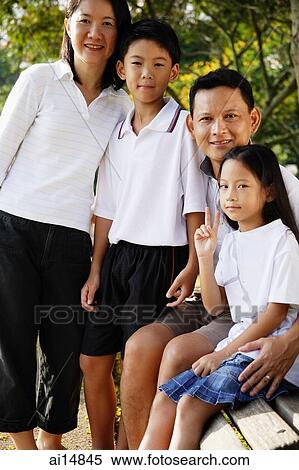 Family with two children, looking at camera View Large Photo Image Stock Photography - Family with two children, looking at camera. Fotosearch