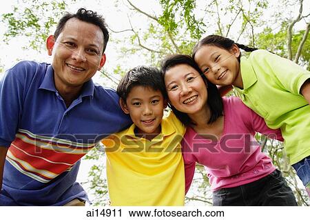Family with two children, looking down at camera View Large Photo Image Stock Image - Family with two children, looking down at camera. Fotosearch