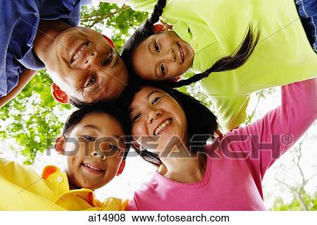 Family with two children, looking down at camera View Large Photo Image Stock Photo - Family with two children, looking down at camera. Fotosearch