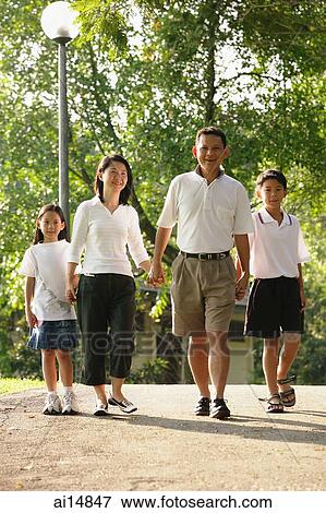 Family with two children, walking hand in hand View Large Photo Image Stock Photo - Family with two children, walking hand in hand. Fotosearch