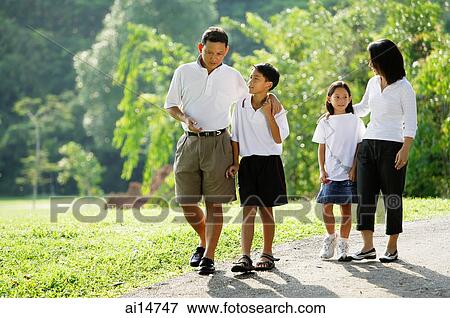 Family with two children, walking in park View Large Photo Image Stock Photo - Family with two children, walking in park. Fotosearch