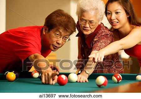 Father and daughter teaching grandmother to play pool View Large Photo Image Stock Photo - Father and daughter teaching grandmother to play pool. Fotosearch