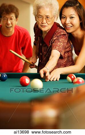 Father and daughter teaching grandmother to play pool View Large Photo Image Stock Photo - Father and daughter teaching grandmother to play pool. Fotosearch