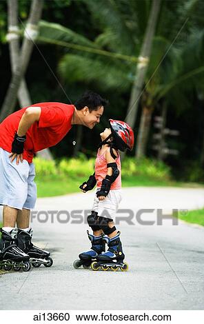 Father and daughter wearing inline skates, father bending to kiss daughter View Large Photo Image Stock Image - Father and daughter wearing inline skates, father bending to kiss daughter. Fotosearch