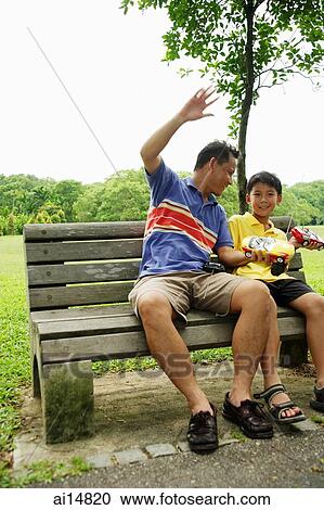 Father and son holding remote control cars, smiling View Large Photo Image Stock Image - Father and son holding remote control cars, smiling. Fotosearch