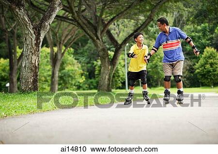 Father and son in-line skating in park, father holding son's hand View Large Photo Image Stock Image - Father and son in-line skating in park, father holding son's hand. Fotosearch