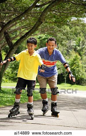 Father and son in park, on roller blades View Large Photo Image Stock Photo - Father and son in park, on roller blades. Fotosearch