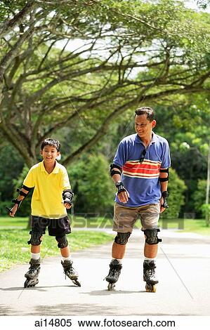 Father and son in park, on roller blades View Large Photo Image Stock Photography - Father and son in park, on roller blades. Fotosearch