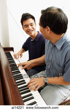 Father and son playing piano, side by side View Large Photo Image Stock Image - Father and son playing piano, side by side. Fotosearch