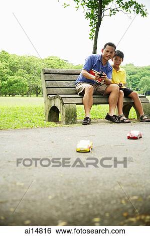 Father and son playing with remote control cars View Large Photo Image Stock Photograph - Father and son playing with remote control cars. Fotosearch
